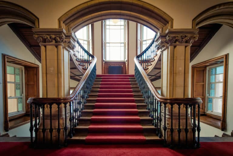 Purcell House stair case with bright red carpet in DCU Rooms All Hallows Campus