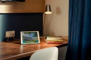 Desk area with lamp, chair, and laptop.
