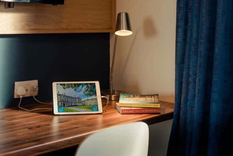Desk area with lamp, chair, and laptop.